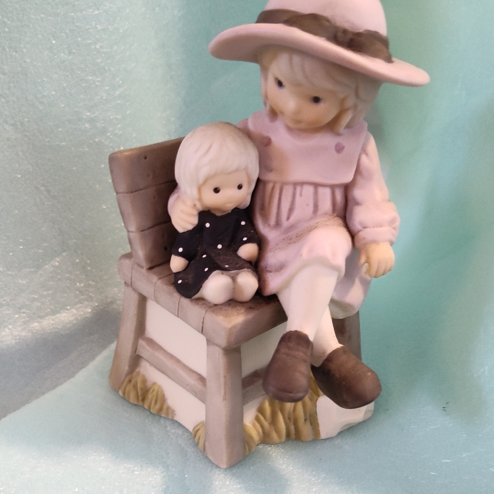 The figurine is the "Mommy In Training" figurine from the "Pretty as a Picture"